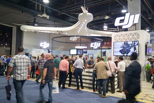 Custom trade show stand for DJI with large crowd forming