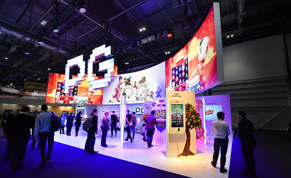 Colourful expo stand with digital led screens and people standing in expo booth