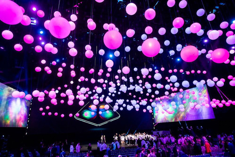 Pink balloons hovering in the air at a trade show