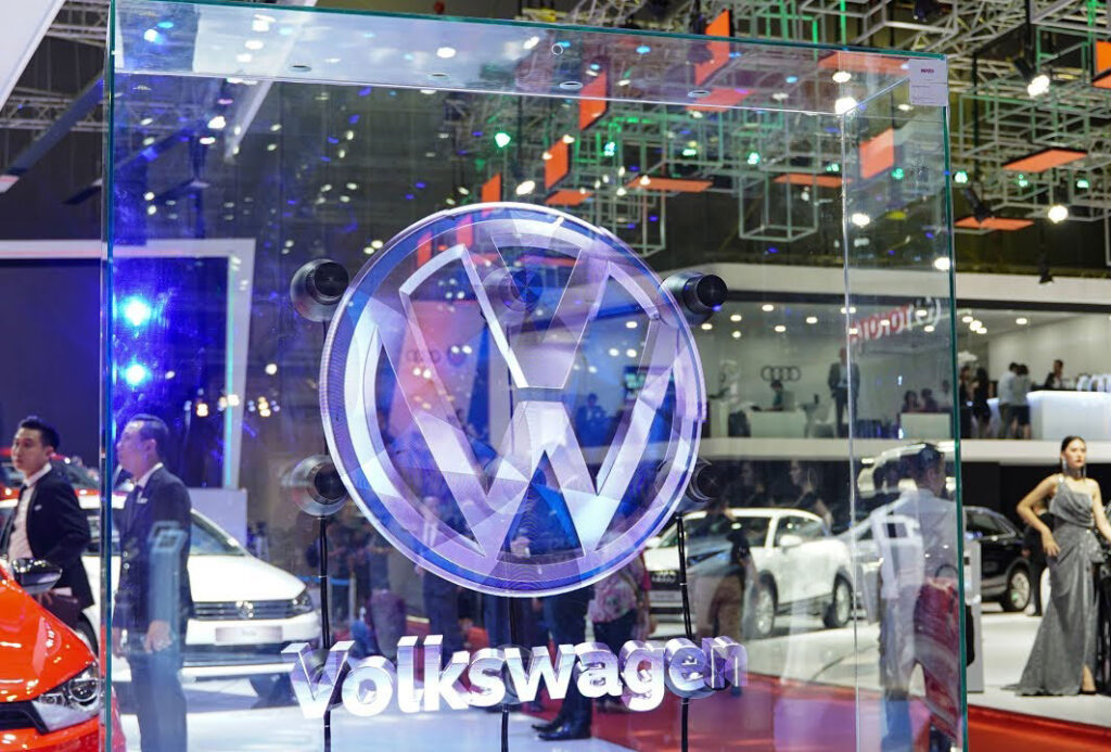 Hologram fan displaying 3D Volkswagen logo within trade show venue