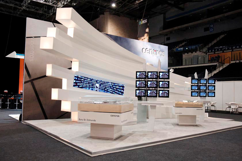 Custom expo stand with white raised flooring and custom architecture elements